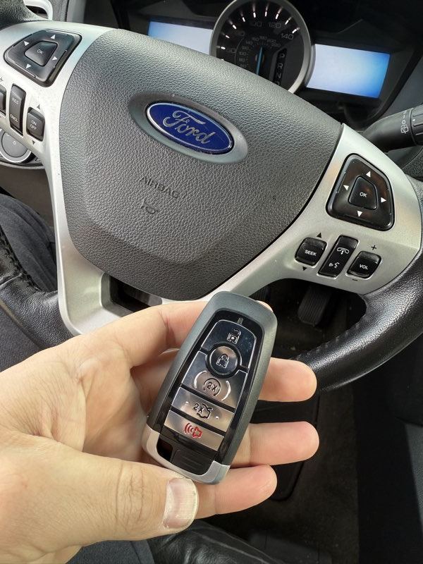 Replacement Ford key fob tested at the steering column during programming