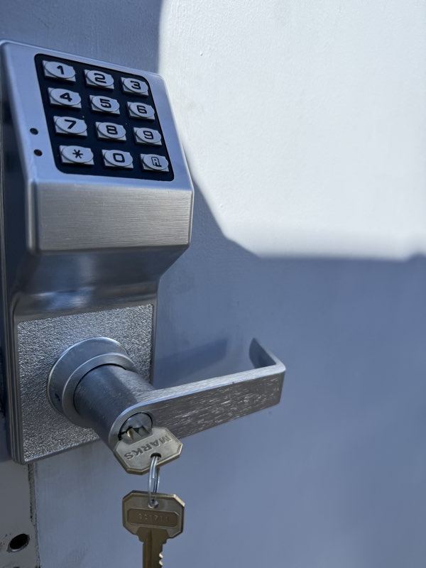 Commercial keypad lock and electric strike installed on an office door